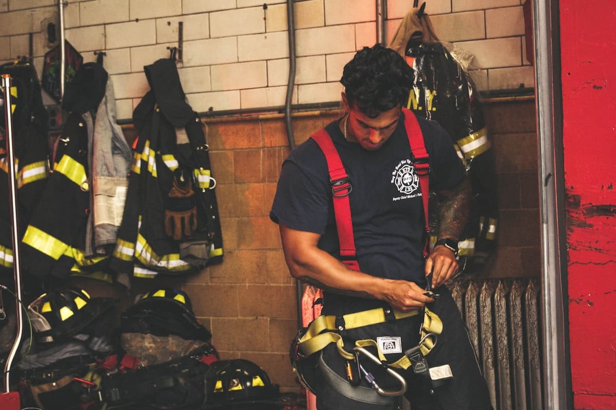 Firefighter training with harness and gear during certification exercise