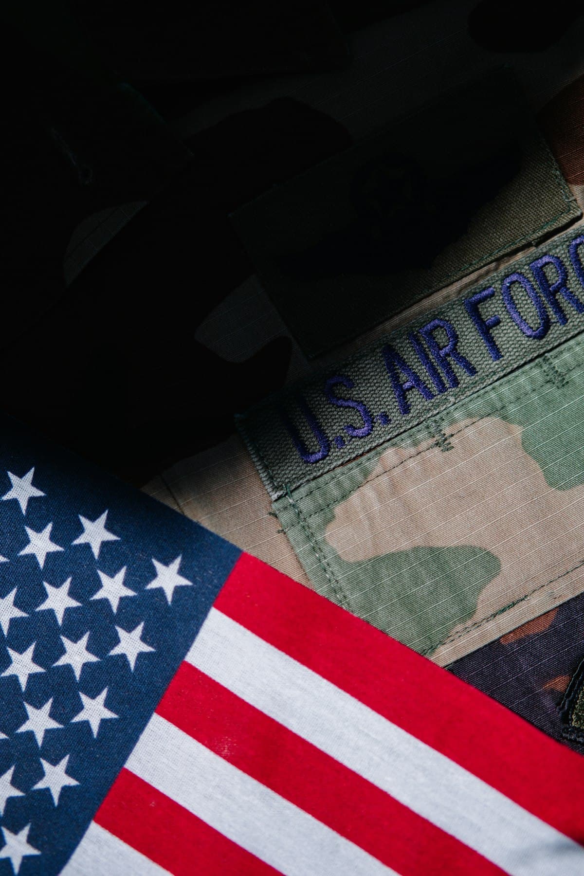 Close up of a U.S. Army uniform next to an American flag representing veteran-owned business pride